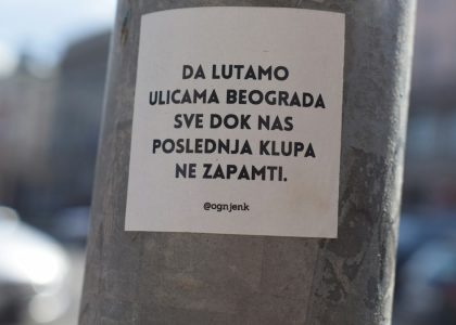 a sticker on a pole on a city street